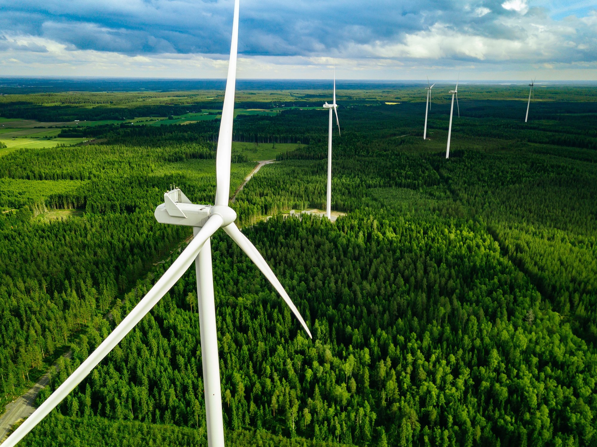 aerial-view-of-windmills-in-green-summer-forest-in-2023-11-27-05-12-44-utc