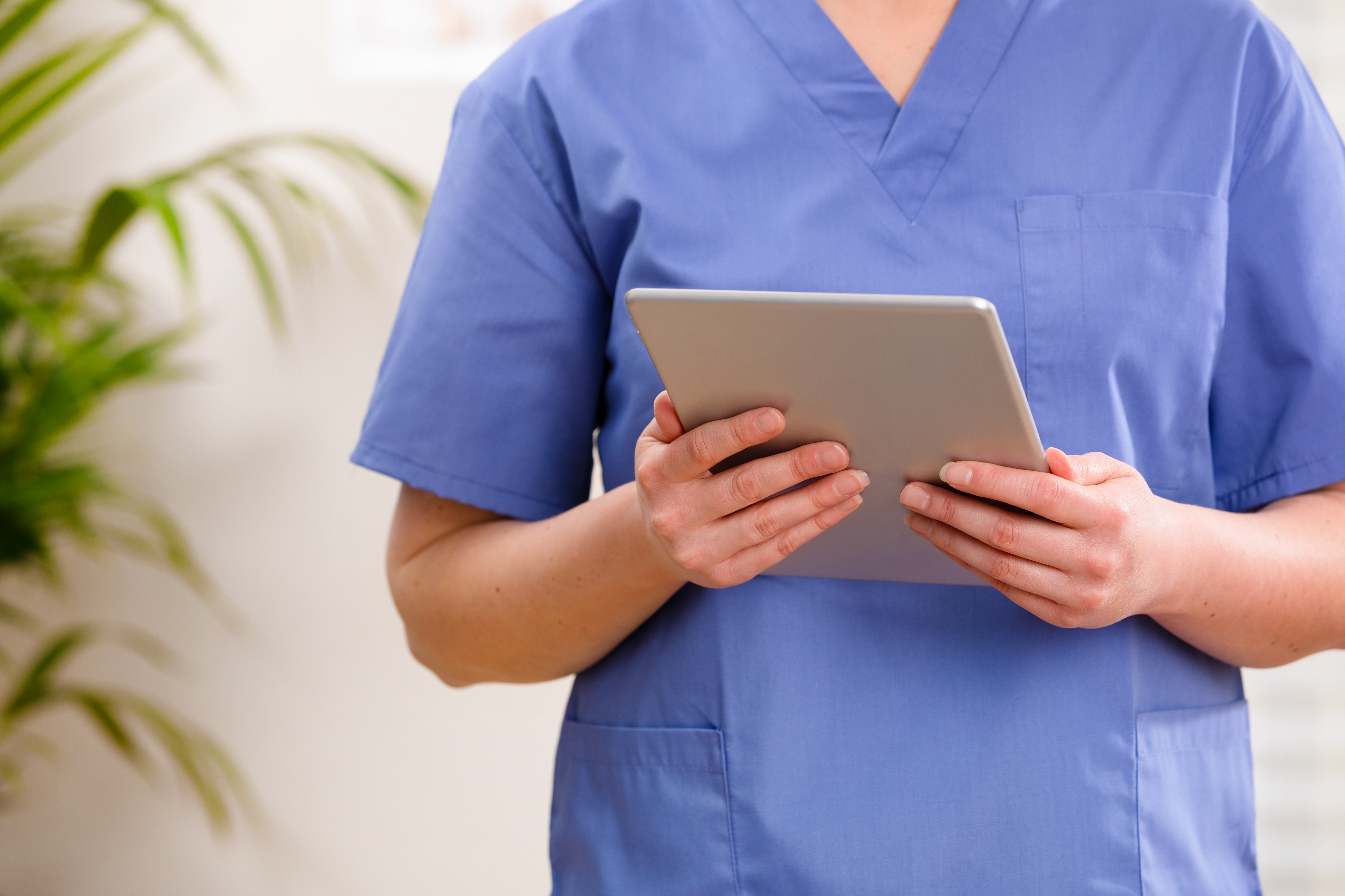 adult-female-doctor-or-nurse-looking-at-a-digital-2022-12-16-09-54-45-utc